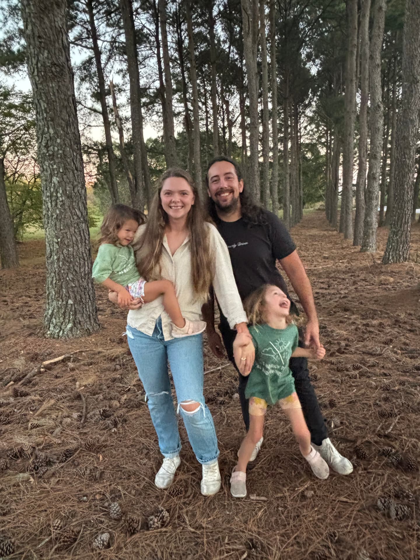 Dr. Shannon with her husband and two young daughters outdoors