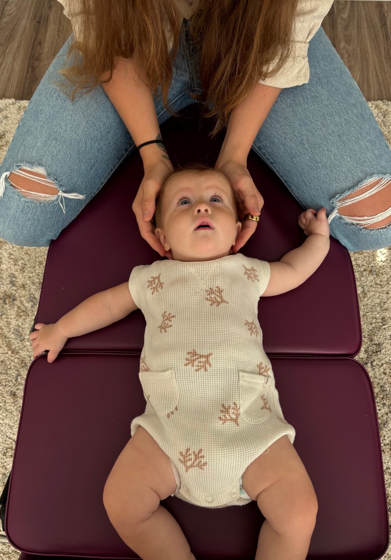 Dr. Shannon gently adjusting a baby with fingertip pressure
